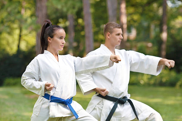 Young couple practicing karate doing Oi-tsuki punch.
